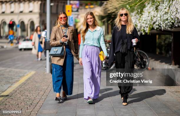 Janka Polliani wearing cropped wide leg denim jeans, brown blazer, blue Loewe bag, Emili Sindlev wearing purple pants, pastel mint top and Jeannette...