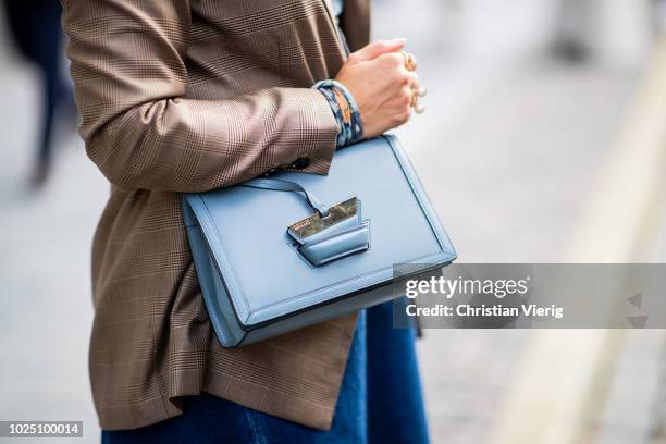 Janka Polliani wearing cropped wide leg denim jeans, brown blazer, blue Loewe bag seen during Stockholm Runway SS19 on August 29, 2018 in Stockholm,...