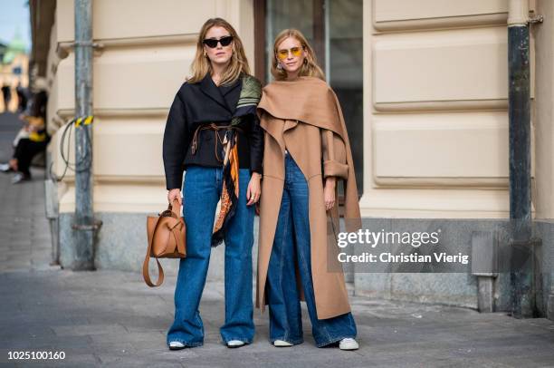 Annabel Rosendahl wearing a brown bag, Loewe scarf, denim jeans and Tine Andrea wearing brown coat, denim jeans seen during Stockholm Runway SS19 on...