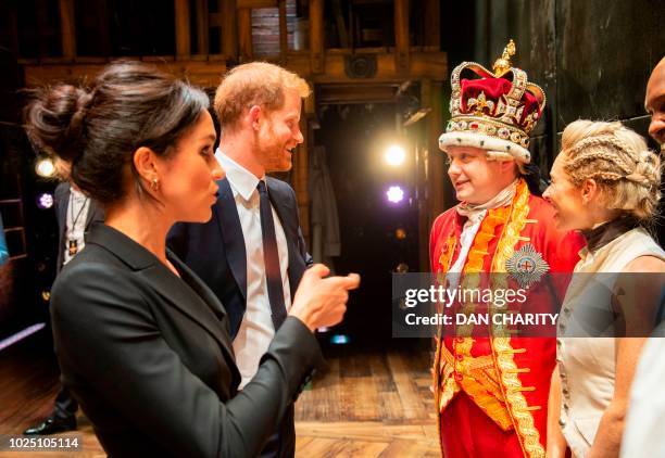 Britain's Prince Harry, Duke of Sussex, and Britain's Meghan, Duchess of Sussex meet members of the cast and crew backstage after a gala performance...