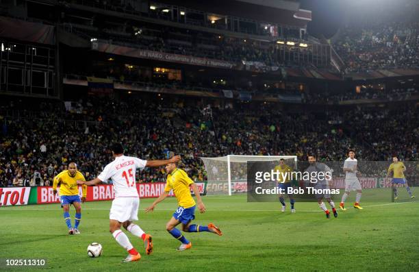 Jean Beausejour of Chile challenged by Dani Alves of Brazil during the 2010 FIFA World Cup South Africa Round of Sixteen match between Brazil and...