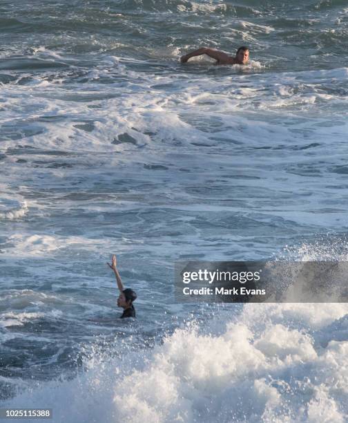 Rescuer swims towards a woman as she cries for help after she was caught in a rip at Bronte beach on August 30, 2018 in Sydney, Australia. The Bureau...