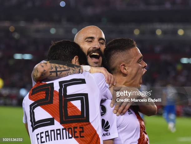 Rafael Santos Borre of River Plate celebrates with teammates Ignacio Fernández and Javier Pinola after scoring the third goal of his team during a...