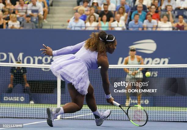 Serena Williams of the US rushes to the net for a return to Carina Witthoeft of Germany during Day 3 of the 2018 US Open Women's Singles match at the...