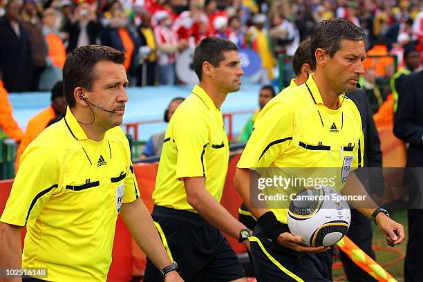 Referee Frank De Bleeckere walks on to the pitch with Assistant Peter Hermans and fourth official Peter O Leary prior to the 2010 FIFA World Cup...