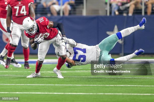 Arizona Cardinals wide receiver Greg Little tries to break free of a tackle by Dallas Cowboys linebacker Damien Wilson during the preseason football...