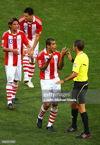 Paulo Da Silva of Paraguay speaks to referee Frank de Bleeckere during the 2010 FIFA World Cup South Africa Round of Sixteen match between Paraguay...