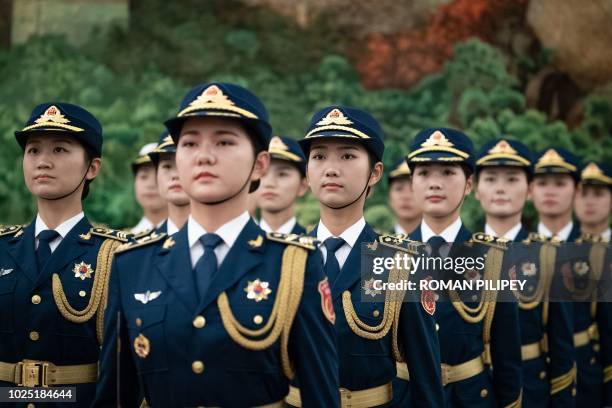 Female members of Chinese People's Liberation Army honour guard wait for the welcome ceremony for Ivory Coast's President Alassane Ouattara at the...