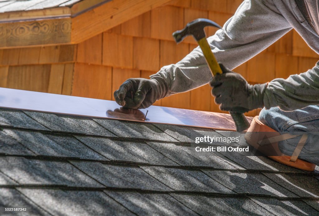 Man installing asphalt roof