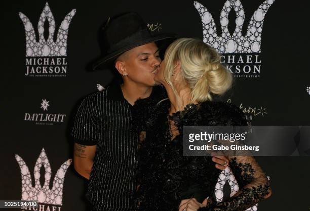 Actor Evan Ross kisses his wife, singer Ashlee Simpson Ross, during the Michael Jackson diamond birthday celebration at Daylight Beach Club at...