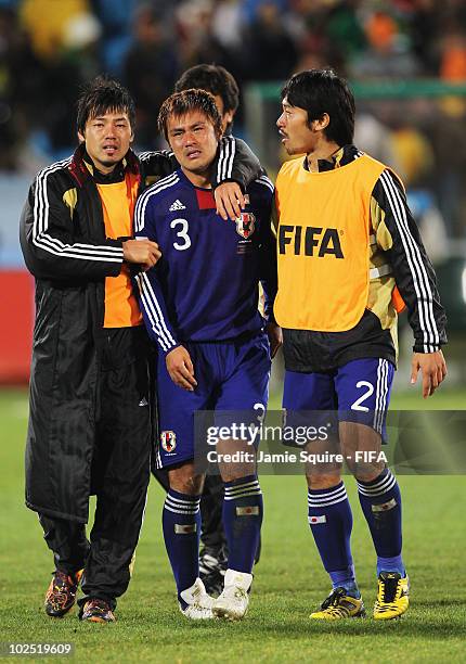 Yuichi Komano of Japan is comforted after missing a penalty during the penalty shoot out during the 2010 FIFA World Cup South Africa Round of Sixteen...