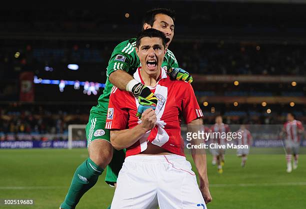 Justo Villar celebrates with Oscar Cardozo of Paraguay after scoring his penalty to win his team a penalty shoot-out during the 2010 FIFA World Cup...