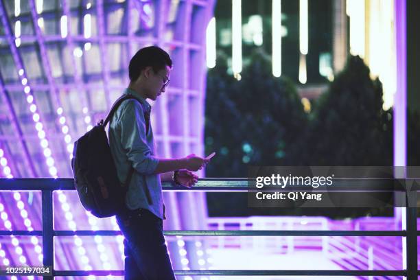 young businessman looking at smartphone, shanghai, china - viollet creative selects stock pictures, royalty-free photos & images