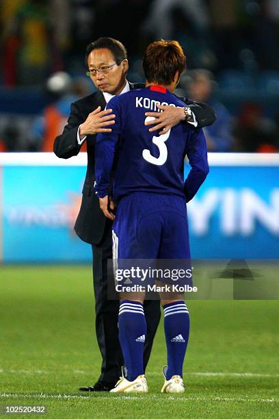 Takeshi Okada head coach of Japan hugs dejected Yuichi Komano after his missed penalty ultimately sends Japan out of the tournament in a shoot-out...