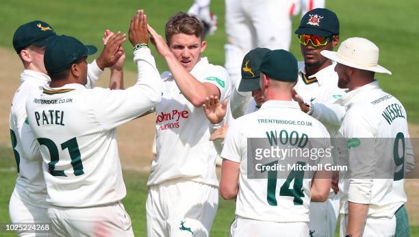 Matt Milnes of Nottinghamshire celebrate taking the wicket of Tom Curran of Surrey during day two of the Specsavers County Championship match between...