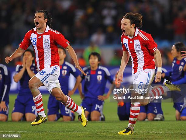Nelson Valdez and Edgar Barreto of Paraguay celebrate after the penalty shoot out during the 2010 FIFA World Cup South Africa Round of Sixteen match...