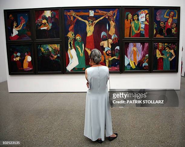 Visitor stands in front of the painting "Das Abendmahl" by Emil Nolde at "The most Beautiful Museum in the World" exhibition at the Museum Folkwang...