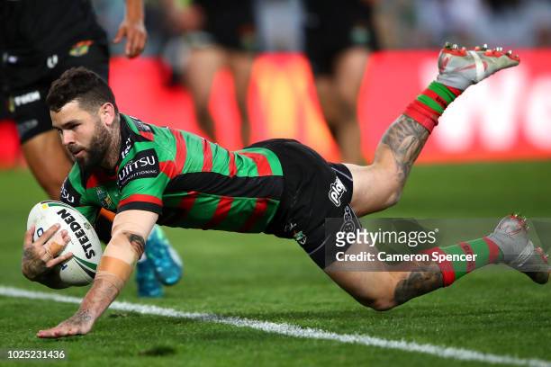 Adam Reynolds of the Rabbitohs scores a try during the round 25 NRL match between the South Sydney Rabbitohs and the Wests Tigers at ANZ Stadium on...