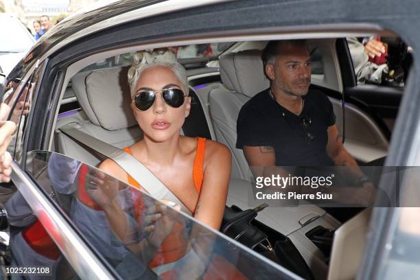 Lady Gaga and her boyfriend Christian Carino leave her hotel on August 30, 2018 in Paris, France.