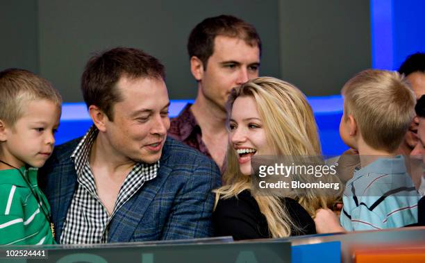 Elon Musk, chairman and chief executive officer of Tesla Motors, second from left, participates in the opening bell ceremony with his twin boys...