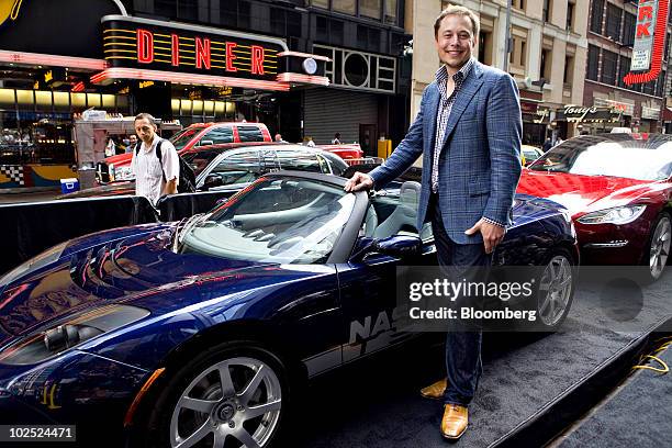 Elon Musk, chairman and chief executive officer of Tesla Motors, stands for a portrait with a Tesla Roadster electric car outside the Nasdaq...