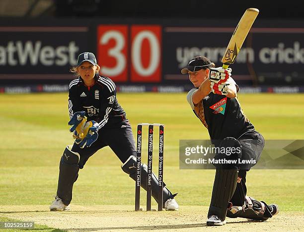 Liz Perry of New Zealand hits the ball towards, Sarah Taylor of England looks on during the 1st Women's NatWest Twenty20 International match between...