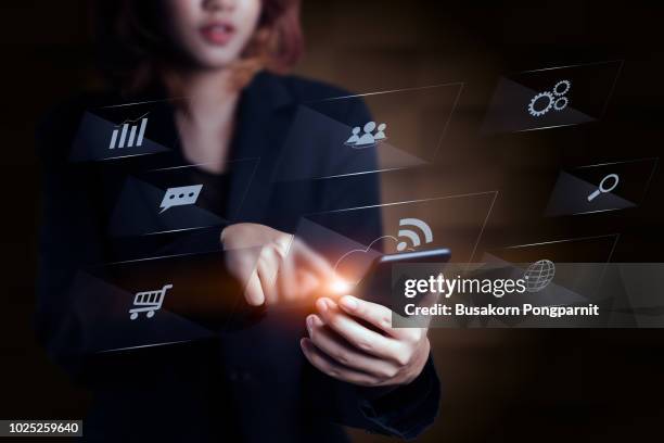 close-up of female hands touching digital smartphone with business diagram technology - smartphone hologram stock pictures, royalty-free photos & images