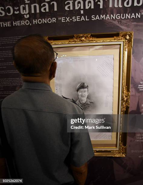 Visitor looks at the portrait of fallen rescuer in last month's Thai cave rescue operation at the interactive exhibition on the rescue operation at...