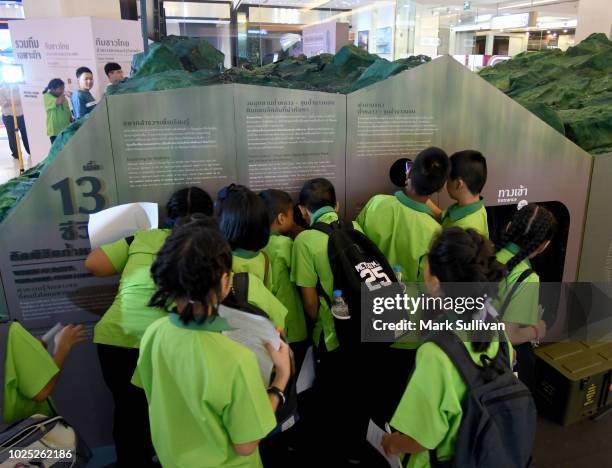 Visitors look at the interactive exhibition on the Thai Cave rescue operation at the Siam Paragon shopping mall on August 30, 2018 in Bangkok,...