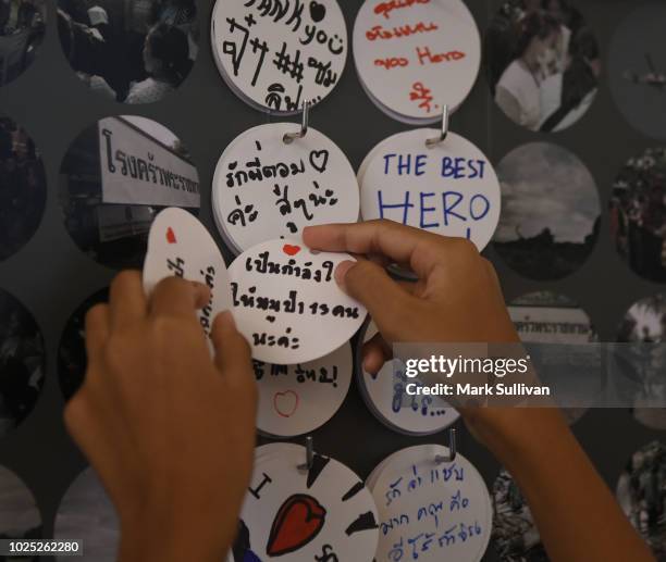 Visitor leaves a message at the interactive exhibition on the Thai Cave rescue operation at the Siam Paragon shopping mall on August 30, 2018 in...