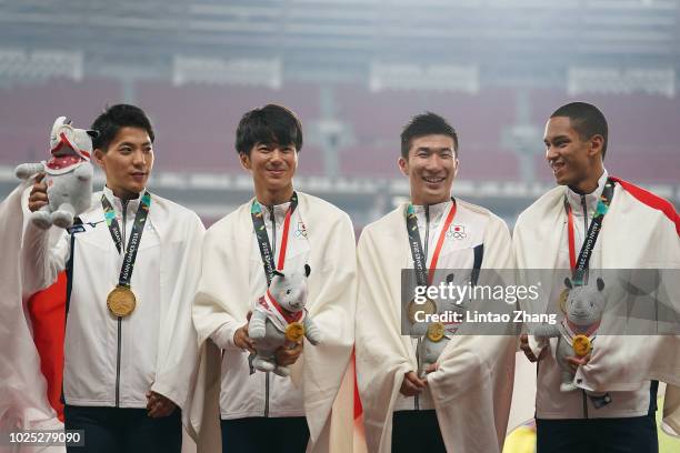 Gold medallists Ryota Yamagata, Shuhei Tada, Yoshihide Kiryu and Aska Antonio Cambridge from Japan celebrate during the medal ceremony for the men's...