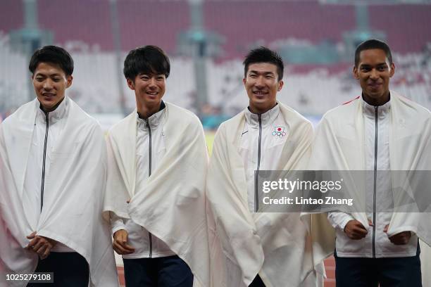 Gold medallists Ryota Yamagata, Shuhei Tada, Yoshihide Kiryu and Aska Antonio Cambridge from Japan celebrate during the medal ceremony for the men's...