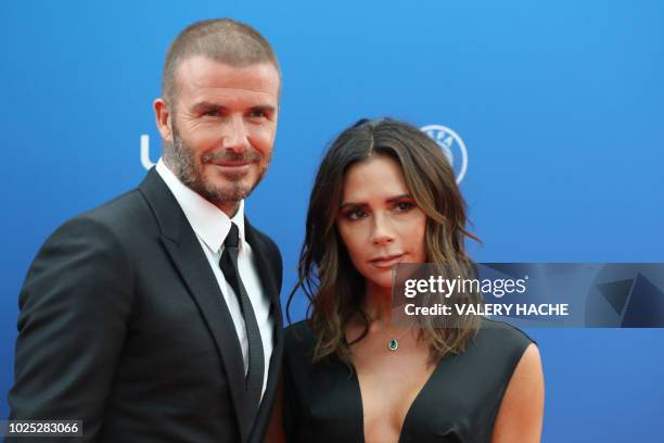 Former English football player David Beckham and his wife Victoria arrive to attend the draw for UEFA Champions League football tournament at The...