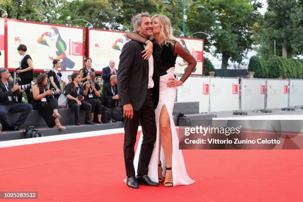 Natasha Stefanenko and Luca Sabbioni walk the red carpet ahead of the 'Roma' screening during the 75th Venice Film Festival at Sala Grande on August...