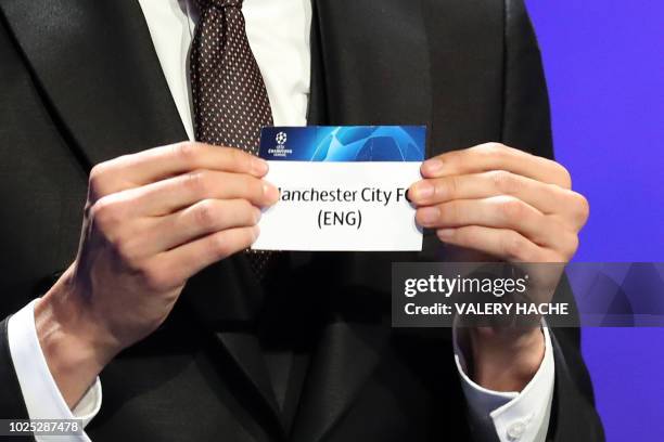 Brazilian former football player Kaka shows the name of Manchester City during the draw for UEFA Champions League football tournament at The Grimaldi...