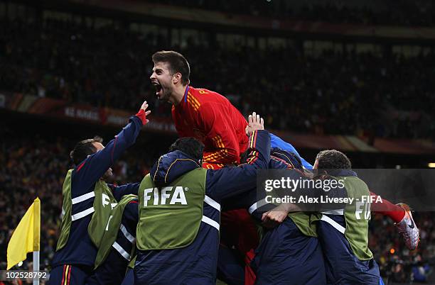 Gerard Pique of Spain celebrates as teammate David Villa scores the opening goal during the 2010 FIFA World Cup South Africa Round of Sixteen match...