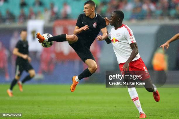 Vladyslav Kabayev of Zorya is challenged by Ibrahima Konate of Leipzig during the UEFA Europa League Qualifying Play-Off second leg match between RB...