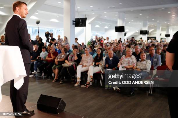 Minister President of Saxony, Michael Kretschmer addresses a Q&A with members of the public at the stadium of Chemnitz FC on August 30, 2018 amid...
