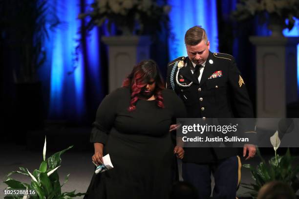 Bridget McCain is escorted her brother during a memorial service to celebrate the life of of U.S. Sen. John McCain at the North Phoenix Baptist...