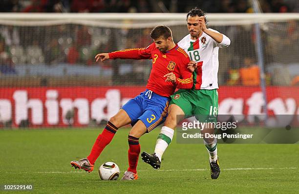 Gerard Pique of Spain is challenged by Hugo Almeida of Portugal during the 2010 FIFA World Cup South Africa Round of Sixteen match between Spain and...