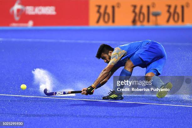 Manpreet Singh of India shoots during Men's Hockey Semifinal match between Malaysia and India at GBK Senayan on day twelve of the Asian Games on...