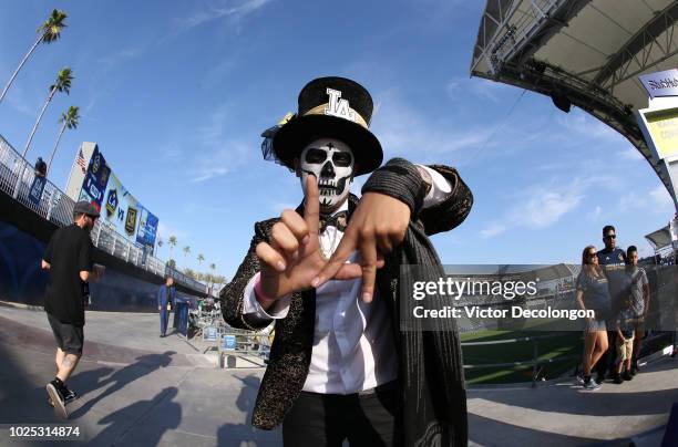 Los Angeles FC supporter holds up his fingers to make a sign of 'LA' prior to the MLS match between the Los Angeles FC and the Los Angeles Galaxy at...