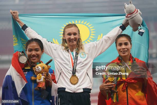 Silver medallist Parinya Chuaimaroeng of Thailand, gold medallist Olga Rypakova of Kazakhstan and bronze medallist Vu Thi Men of Vietnam celebrates...