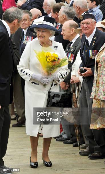 Queen Elizabeth II after being given flowers by a Navy veteran on June 29, 2010 in Halifax, Canada. The Queen and Duke of Edinburgh are on an eight...
