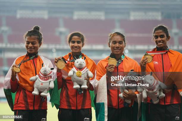 Gold medallist India team celebrate during the medal ceremony for the women's 4x400m relay on day twelve of the Asian Games on August 30, 2018 in...