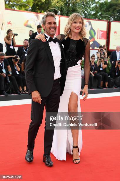 Natasha Stefanenko and Luca Sabbioni walk the red carpet ahead of the 'Roma' screening during the 75th Venice Film Festival at Sala Grande on August...