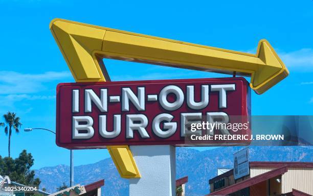 The signs points to an In-N-Out Burger restaurant in Alhambra, California on August 30, 2018. - Califoria's Democratic Party Chairman, Eric Bauman,...