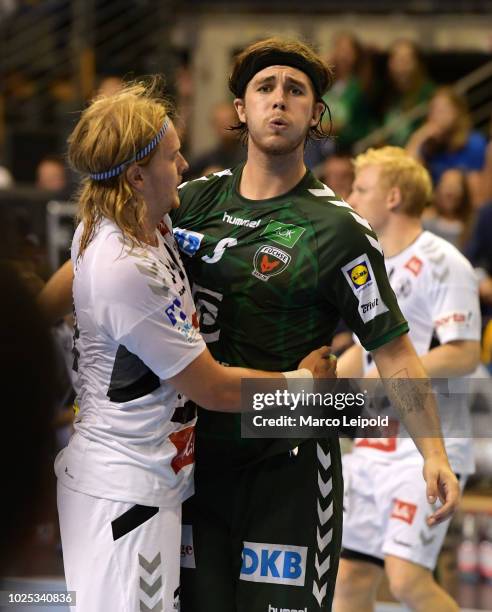 Andreas Cederholm of GWD Minden and Jacob Tandrup Holm of Fuechse Berlin during the game between Fuechse Berlin and GWD Minden at the...