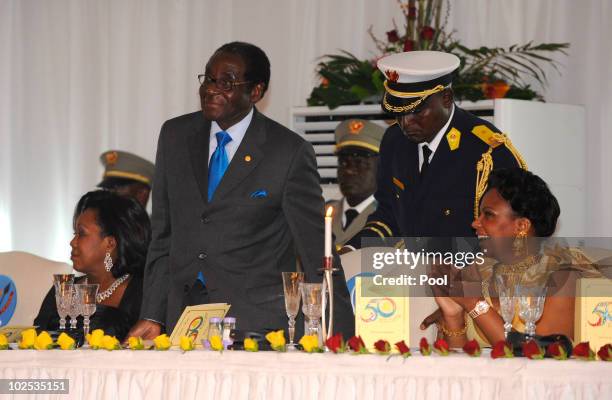 First Lady of Zimbabwe Grace Mugabe, President of Zimbabwe Robert Mugabe, and Congolese First Lady Olive Kabila attend a gala dinner at Cite de...