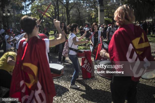 Demonstrators play drums during a rally against local government officials and in support of jailed former president Luiz Inacio Lula da Silva...